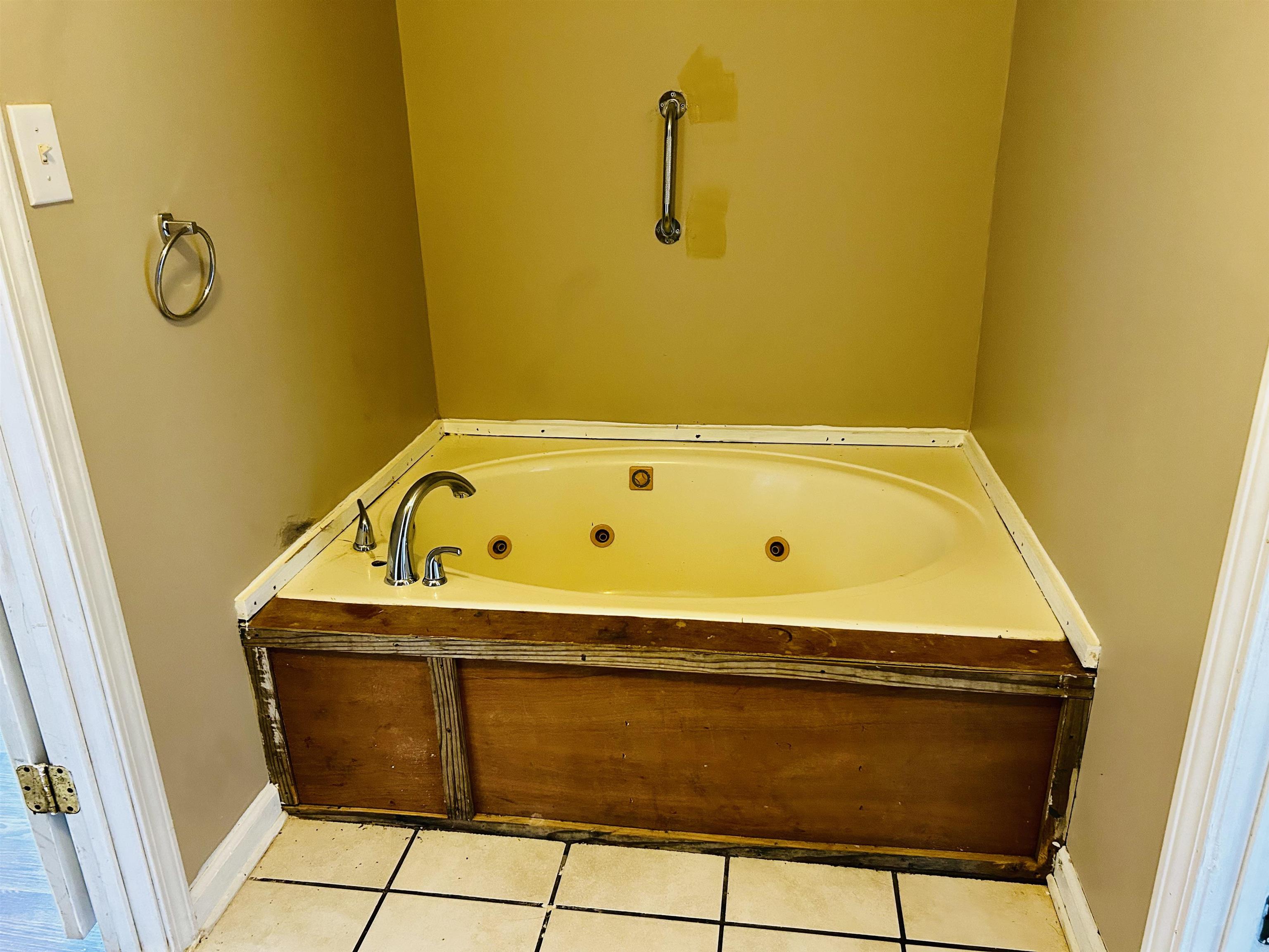 437 Wayne Elam Road Ramer, TN 38367 - Photo 15 of 16 Bathroom with tile patterned flooring and a bathtub
