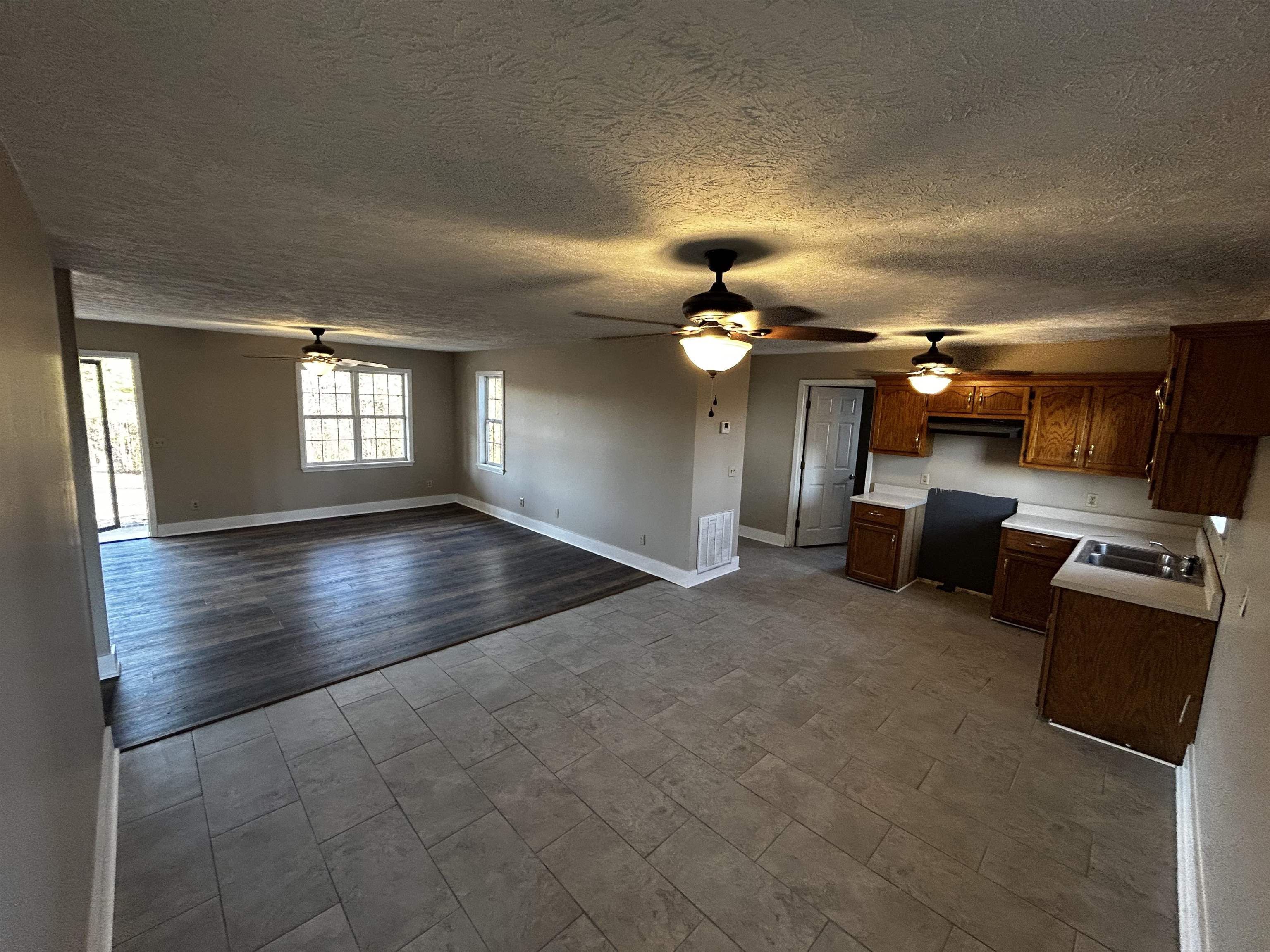 437 Wayne Elam Road Ramer, TN 38367 - Photo 16 of 16 Kitchen with baseboards, visible vents, a sink, light countertops, and open floor plan