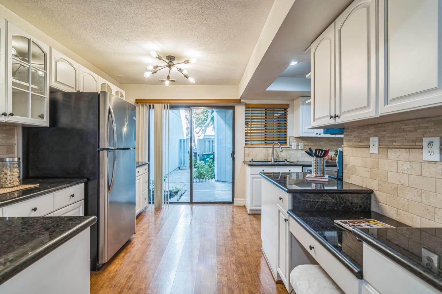 5348 Brookside Court Pleasanton, CA 94588 - Photo 19 of 30 a kitchen with stainless steel appliances granite countertop hardwood floor sink stove and granite counter top