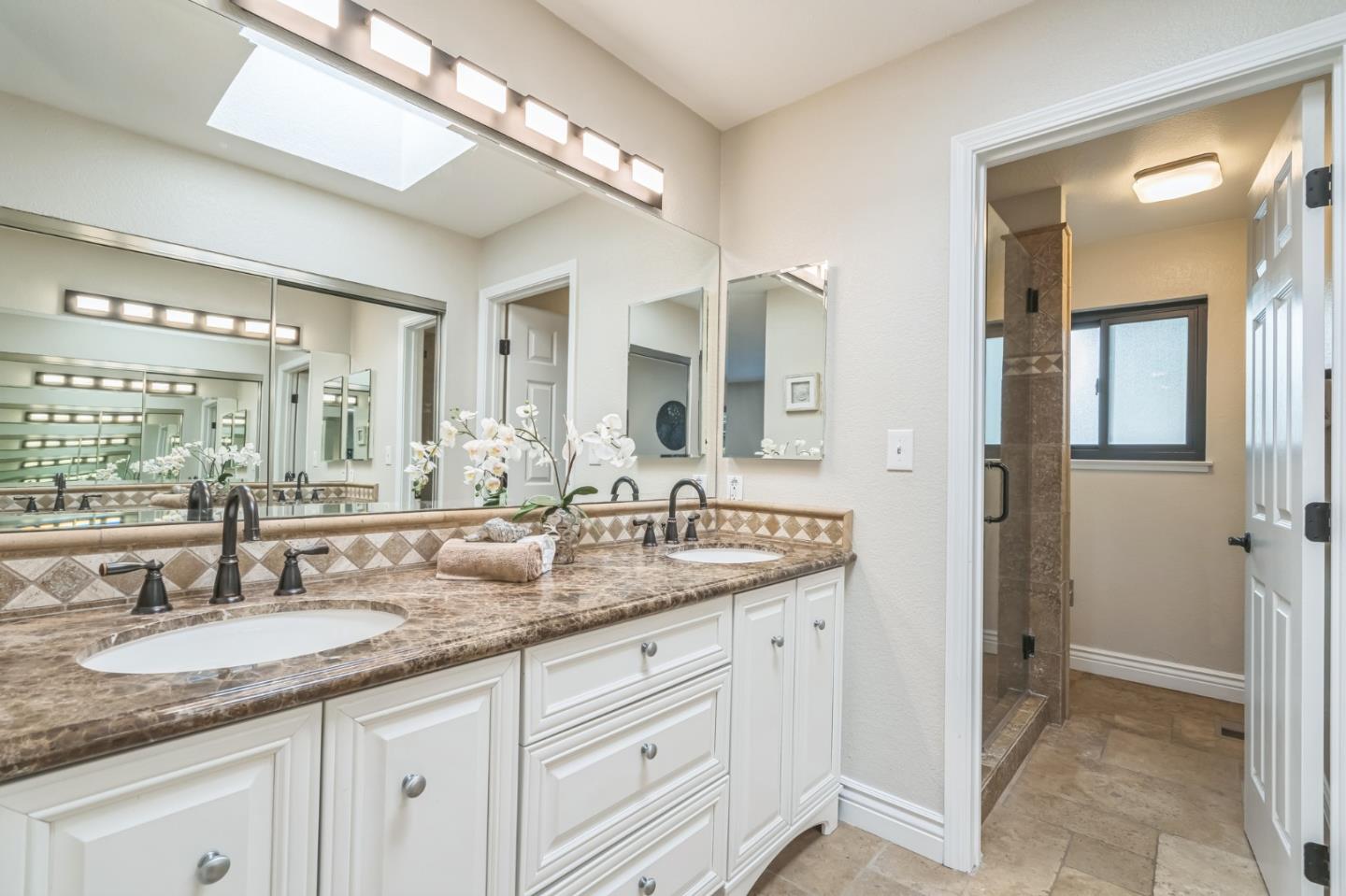5348 Brookside Court Pleasanton, CA 94588 - Photo 21 of 30 a bathroom with a granite countertop double sink and a mirror