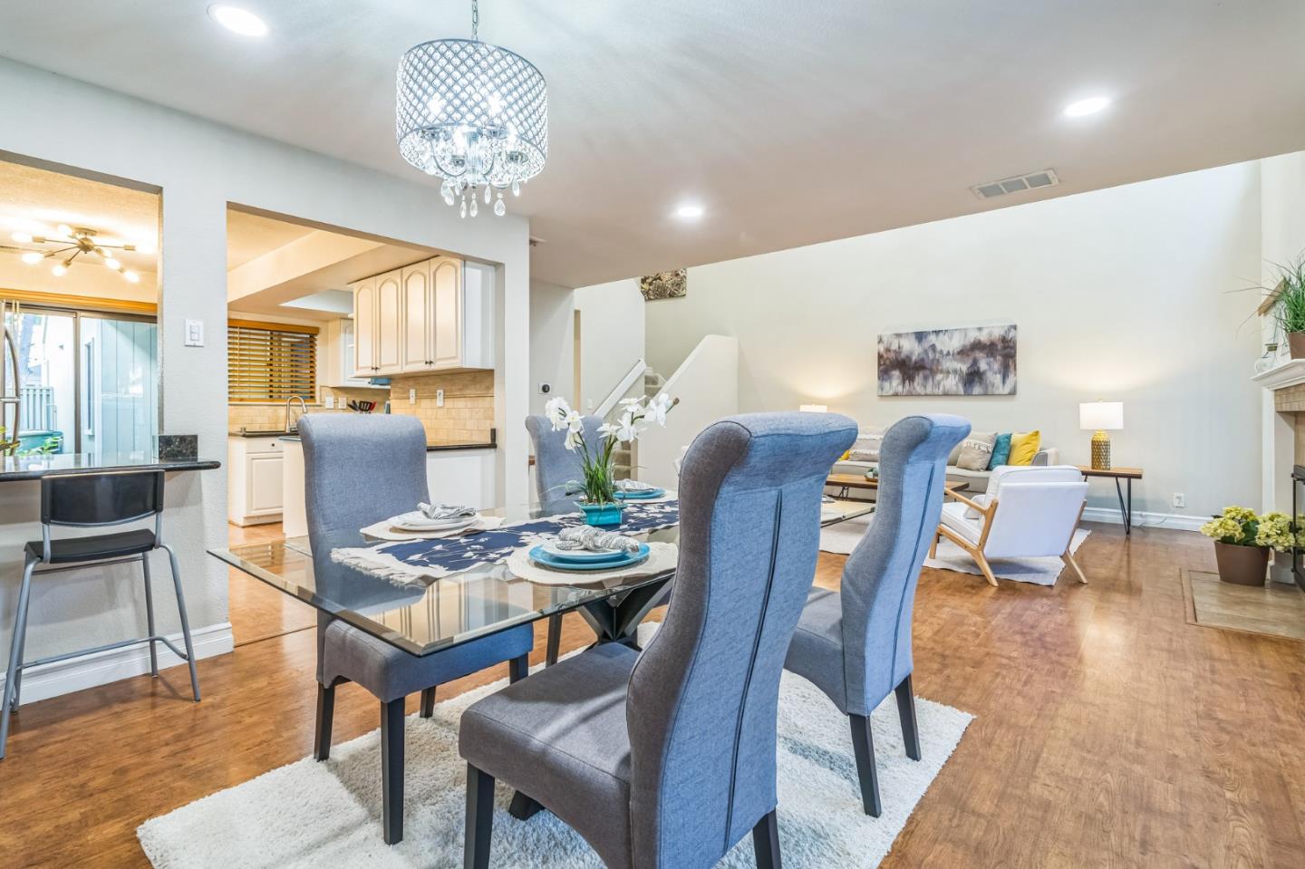 5348 Brookside Court Pleasanton, CA 94588 - Photo 6 of 30 a dining room with furniture a large window and wooden floor