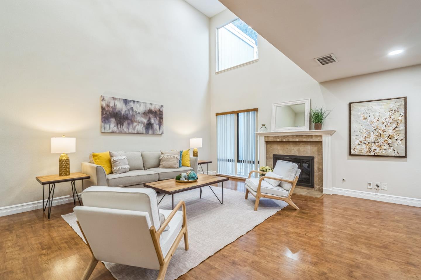 5348 Brookside Court Pleasanton, CA 94588 - Photo 9 of 30 a living room with furniture a fireplace and paintings on the wall