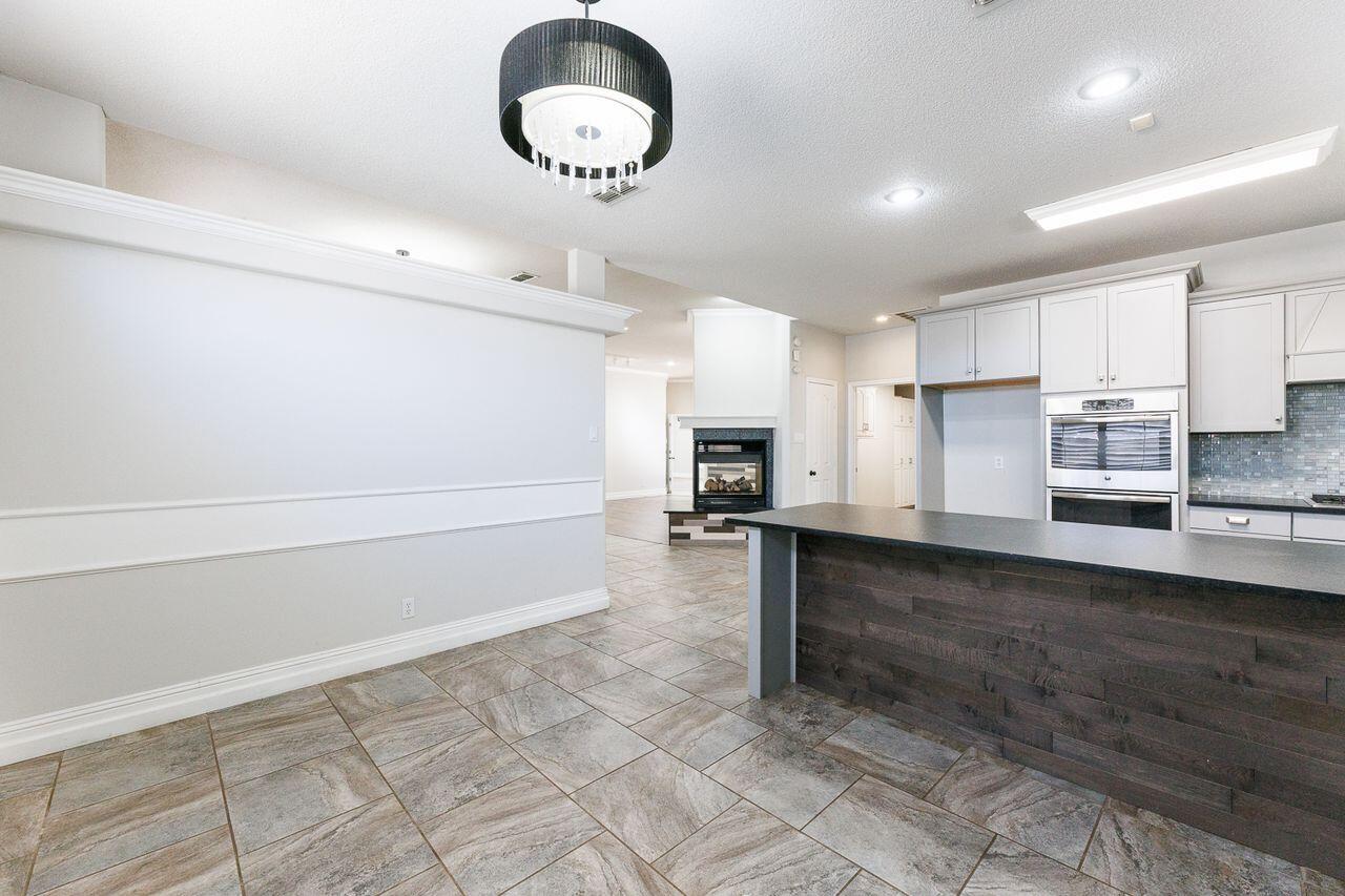 4503 108th Street Lubbock, TX 79424 - Photo 12 of 53 a kitchen with refrigerator and cabinets