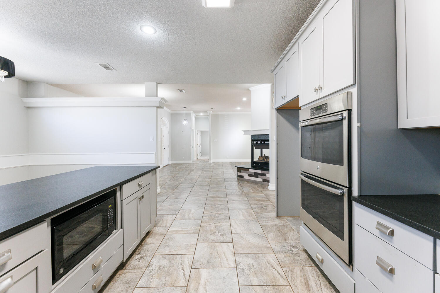 4503 108th Street Lubbock, TX 79424 - Photo 19 of 53 a large kitchen with a large counter top stainless steel appliances and cabinets