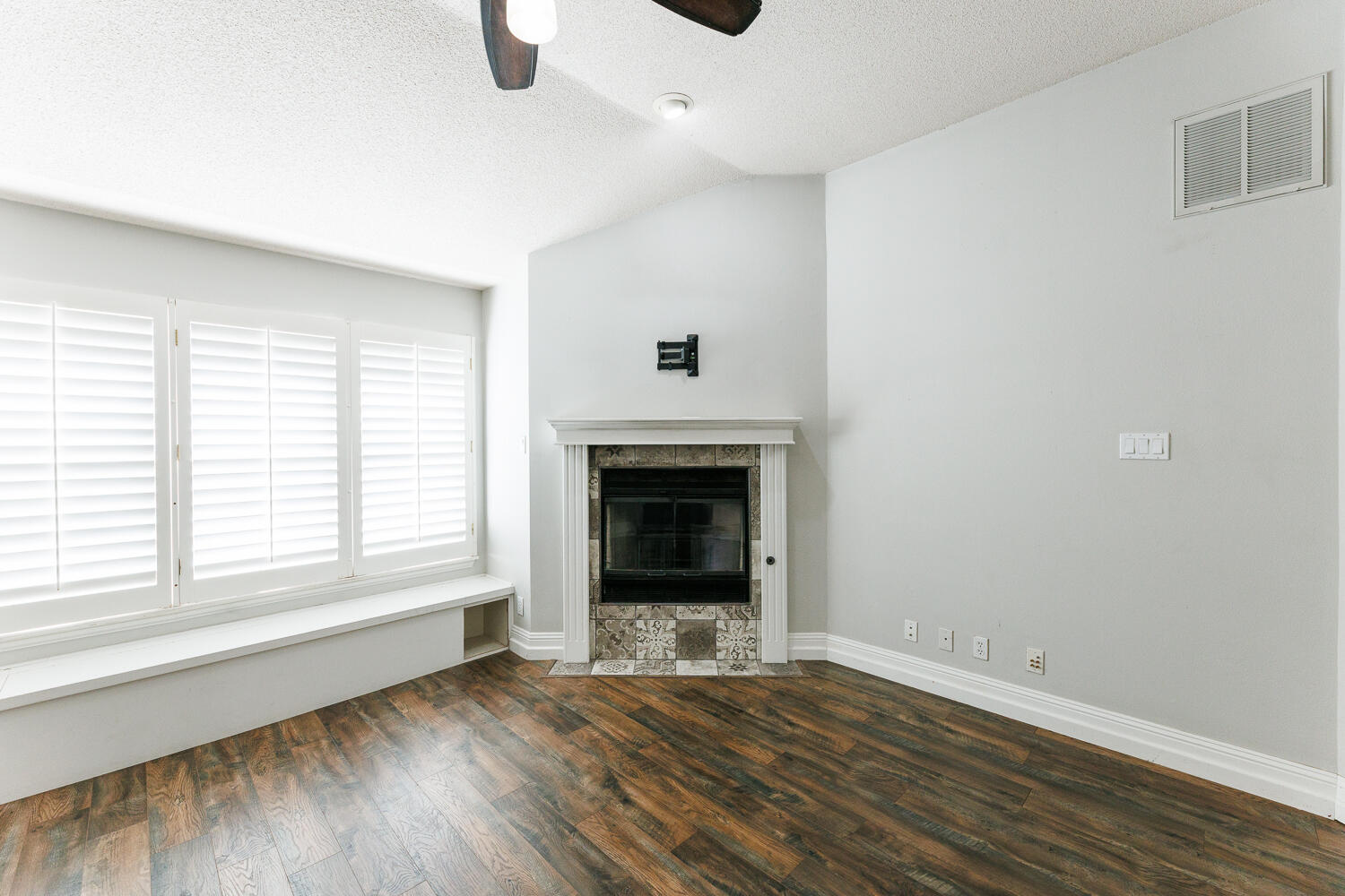 4503 108th Street Lubbock, TX 79424 - Photo 26 of 53 an empty room with wooden floor fireplace and windows