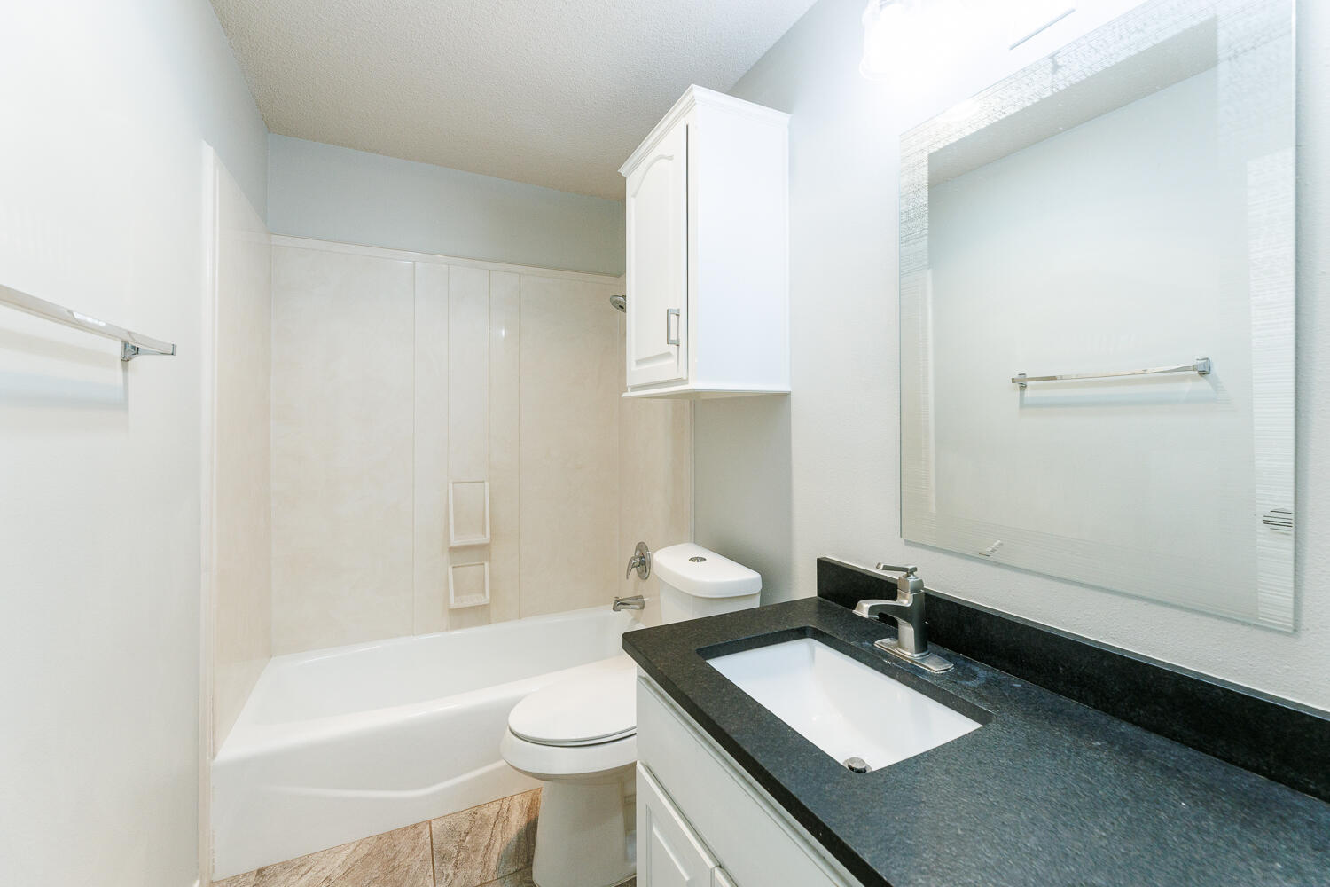 4503 108th Street Lubbock, TX 79424 - Photo 38 of 53 a bathroom with a granite countertop sink toilet and mirror