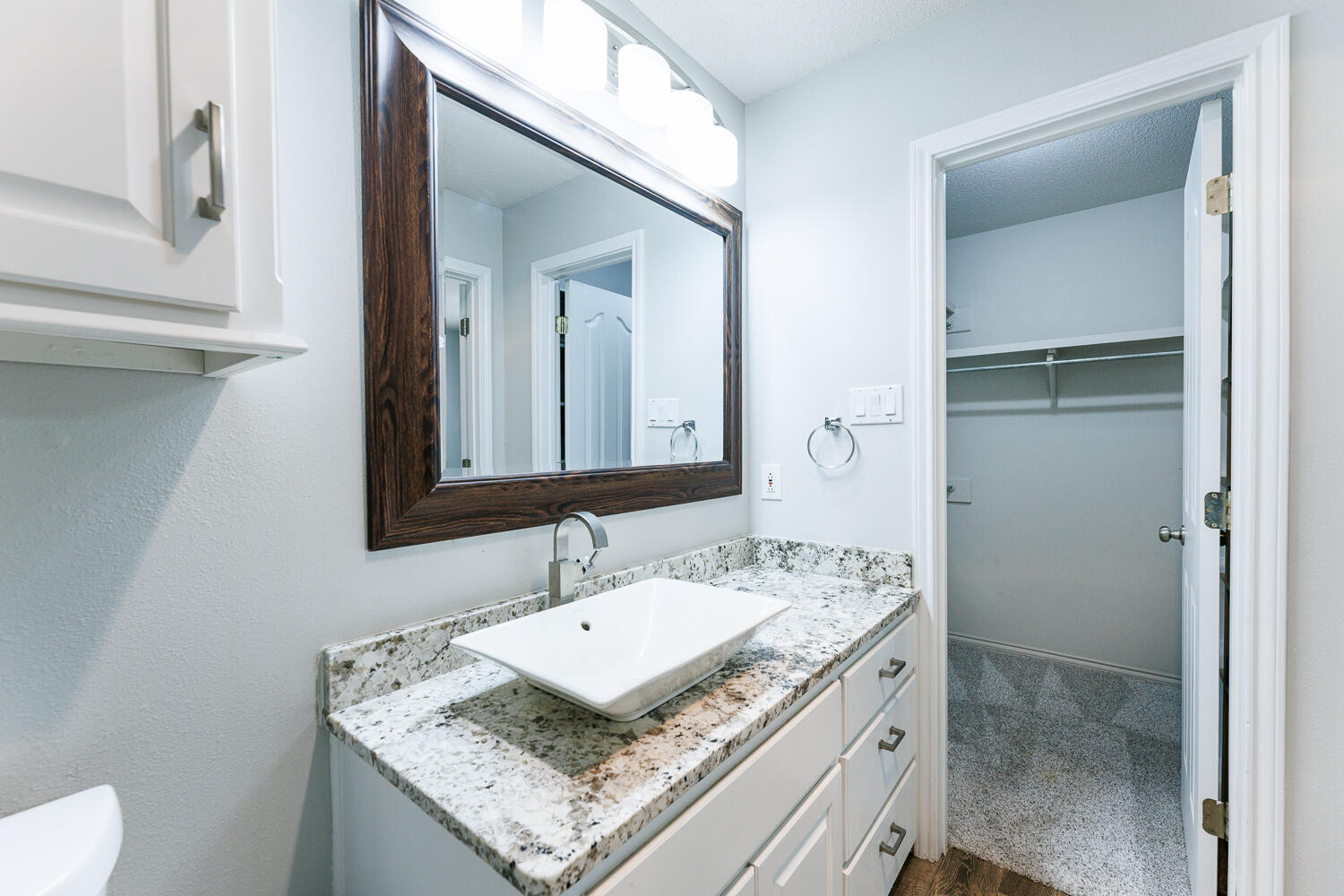 4503 108th Street Lubbock, TX 79424 - Photo 45 of 53 a bathroom with a granite countertop sink and a mirror
