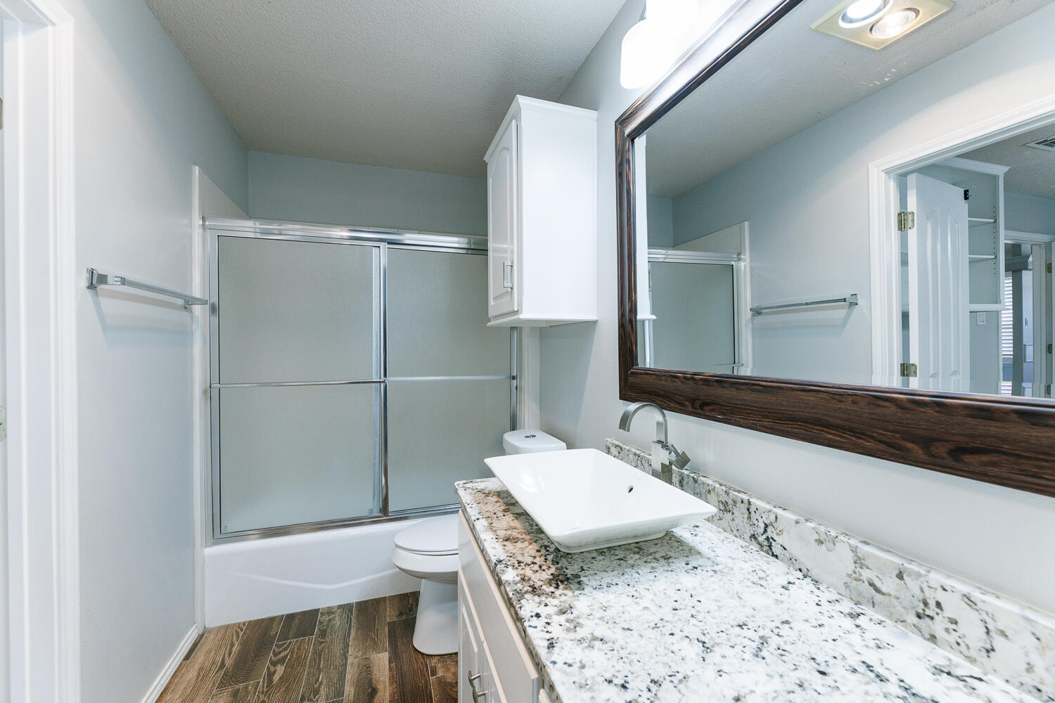 4503 108th Street Lubbock, TX 79424 - Photo 46 of 53 a bathroom with a sink and a mirror