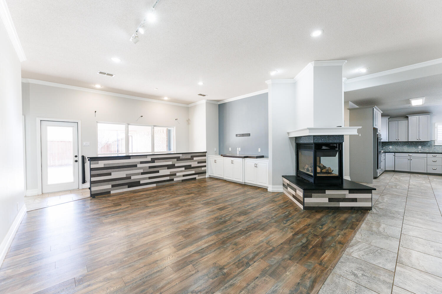 4503 108th Street Lubbock, TX 79424 - Photo 8 of 53 a view of a room with wooden floor and a fireplace