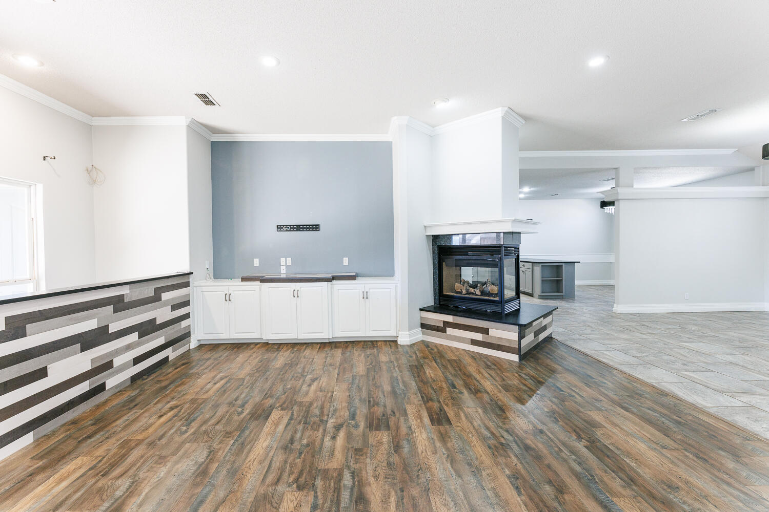 4503 108th Street Lubbock, TX 79424 - Photo 9 of 53 a view of an empty room with fire place and wooden floor