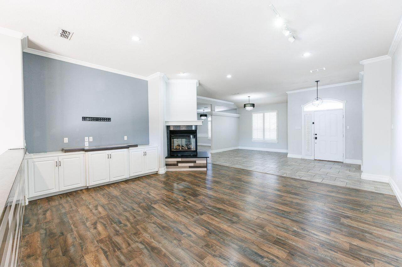 4503 108th Street Lubbock, TX 79424 - Photo 10 of 53 a view of an empty room with window and wooden floor