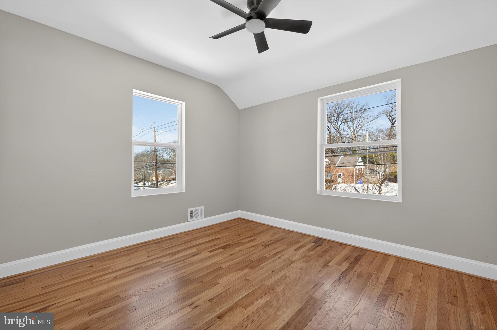 914 Dennis Avenue Silver Spring, MD 20901 - Photo 21 of 37 a view of an empty room with wooden floor and a window