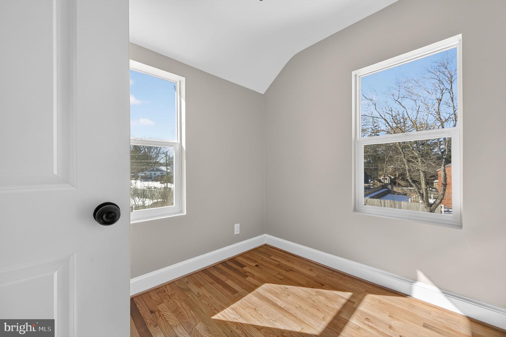 914 Dennis Avenue Silver Spring, MD 20901 - Photo 24 of 37 a view of a bedroom with wooden floor and a window