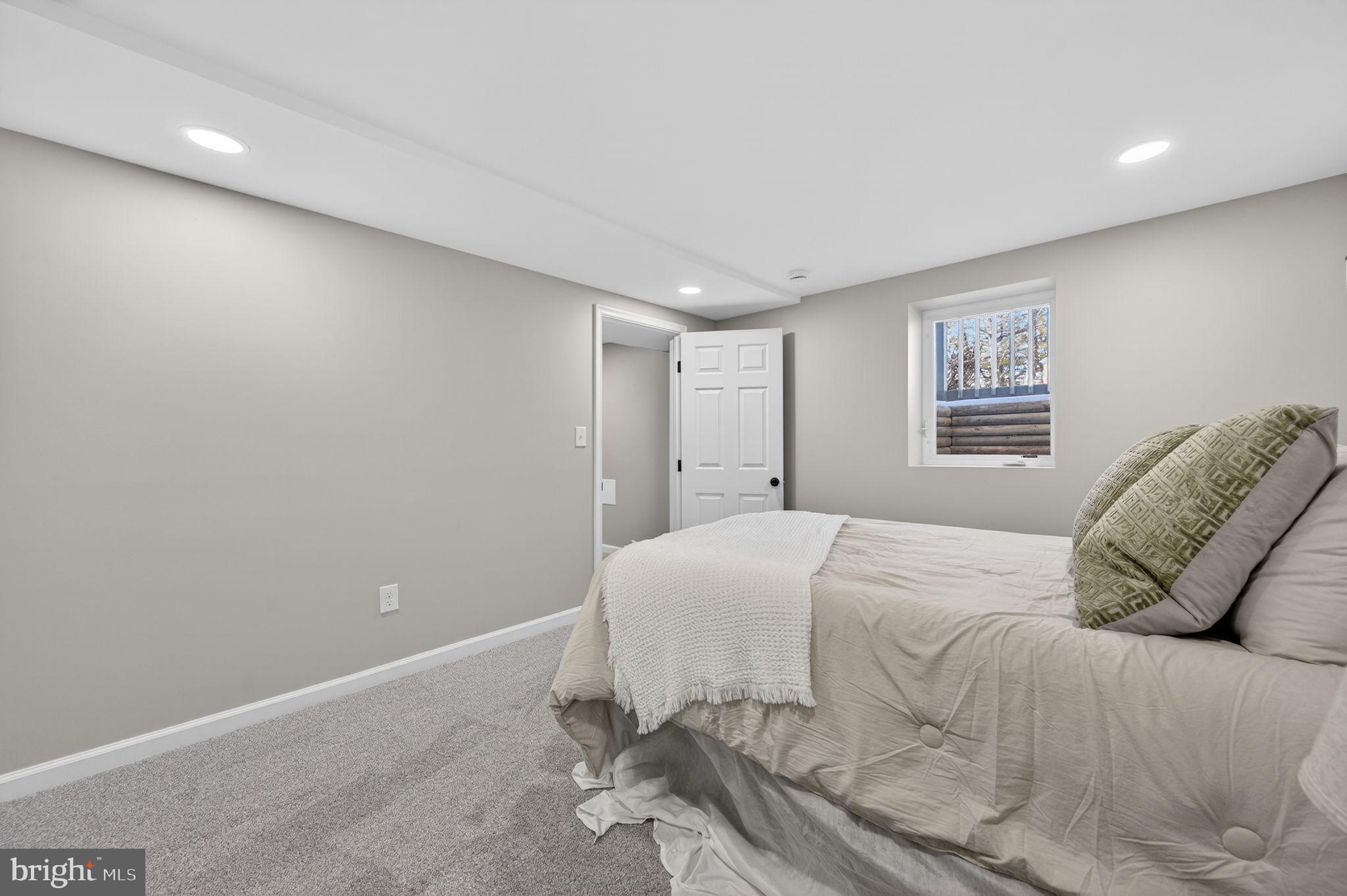 914 Dennis Avenue Silver Spring, MD 20901 - Photo 27 of 37 a spacious bedroom with a bed and a couch