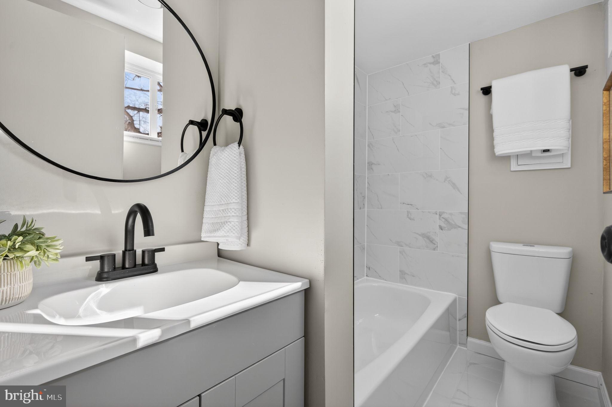 914 Dennis Avenue Silver Spring, MD 20901 - Photo 29 of 37 a bathroom with a sink a toilet and a mirror