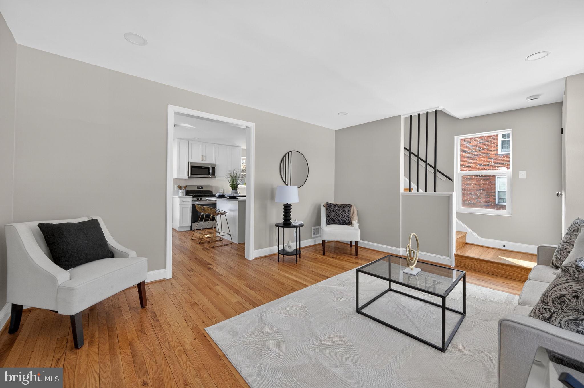 914 Dennis Avenue Silver Spring, MD 20901 - Photo 6 of 37 a living room with furniture a rug and a table
