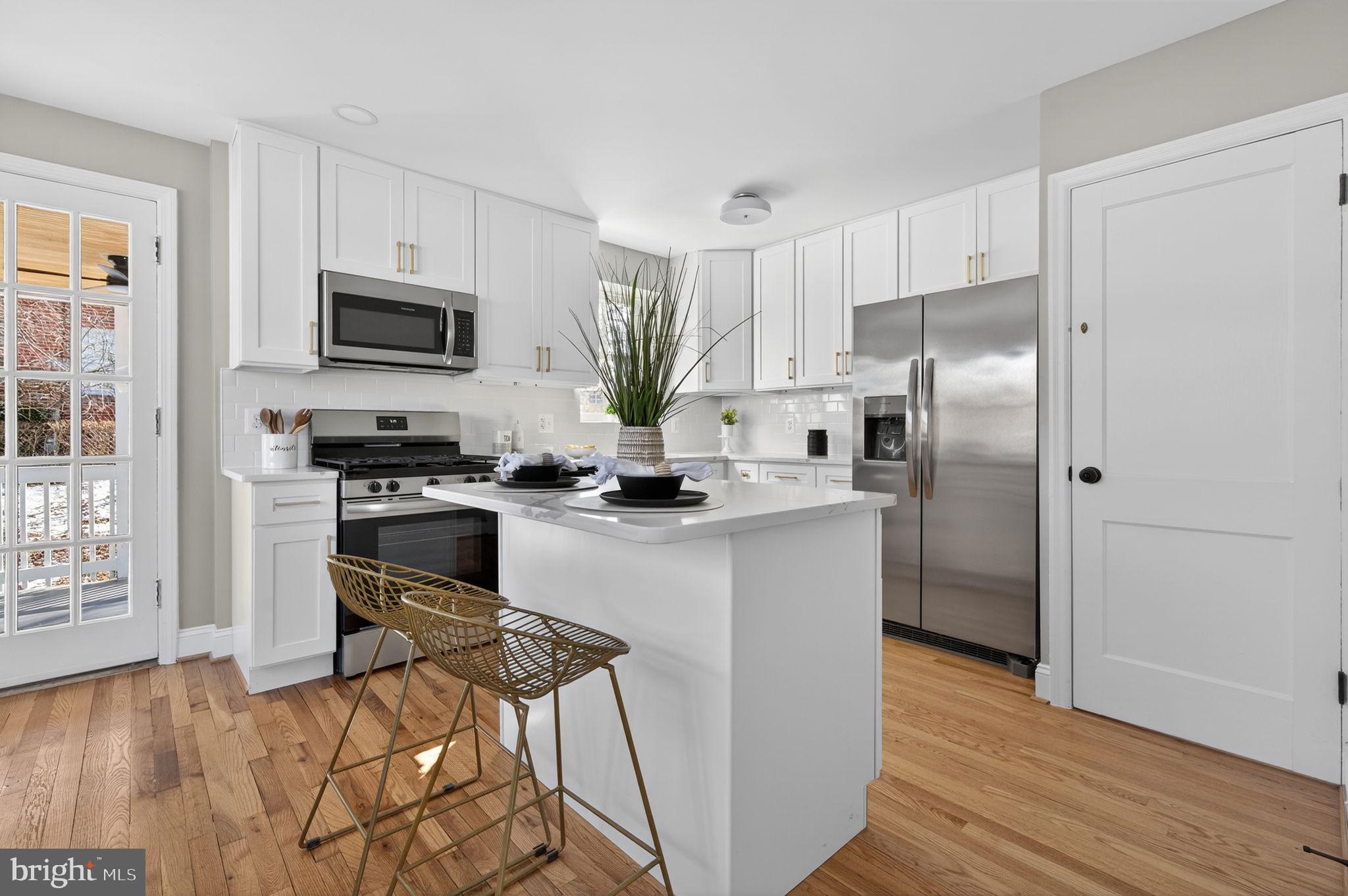914 Dennis Avenue Silver Spring, MD 20901 - Photo 10 of 37 a kitchen with stainless steel appliances a refrigerator stove and microwave