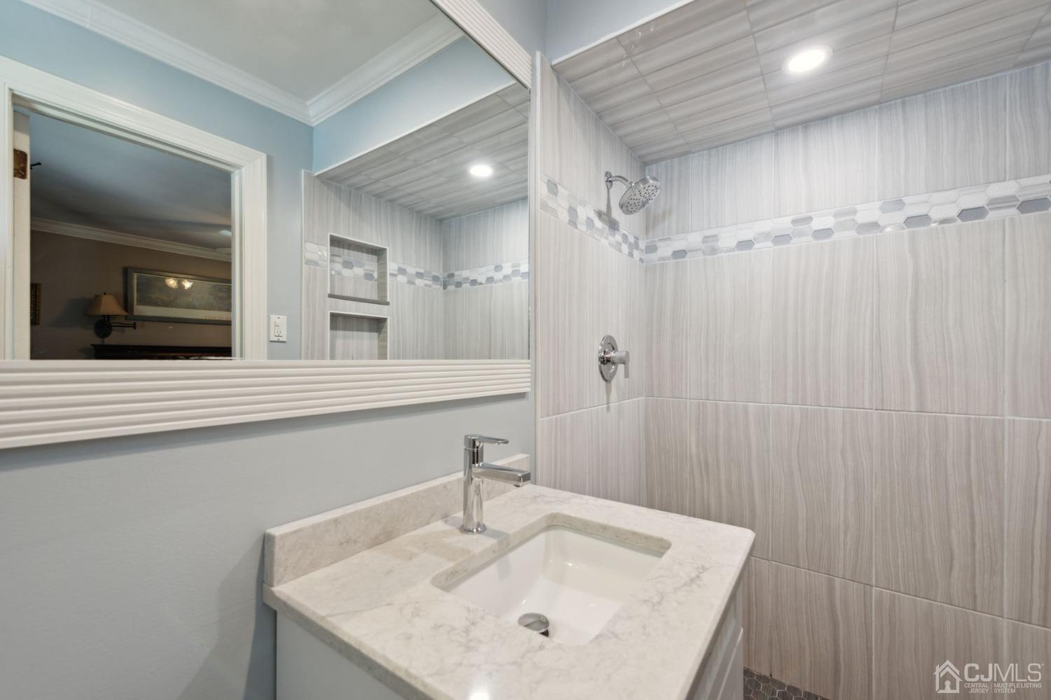 23 Kings Road East Brunswick, NJ 08816 - Photo 31 of 45 a bathroom with a sink and a mirror