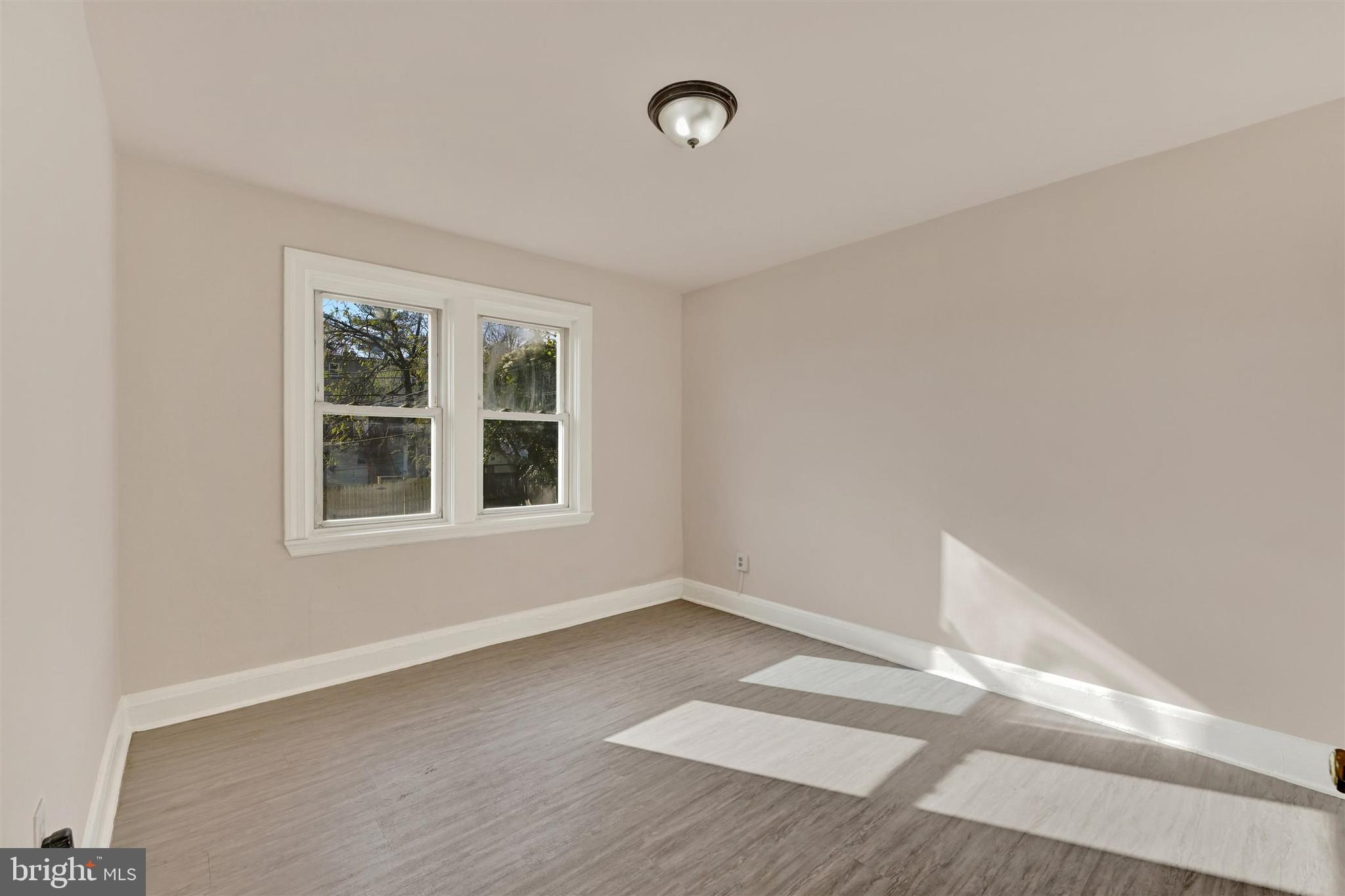 1509 Filbert Street Curtis Bay, MD 21226 - Photo 11 of 28 an empty room with wooden floor and windows