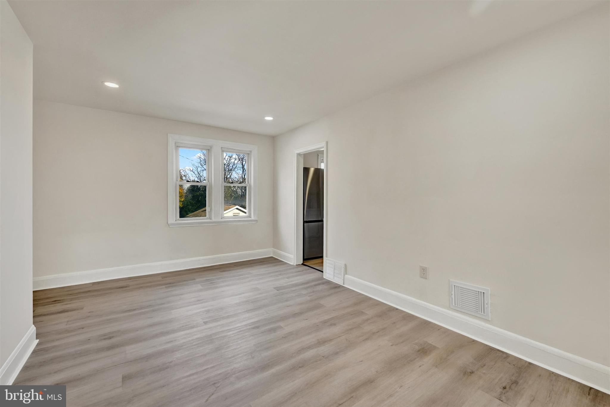1509 Filbert Street Curtis Bay, MD 21226 - Photo 13 of 28 an empty room with wooden floor and windows