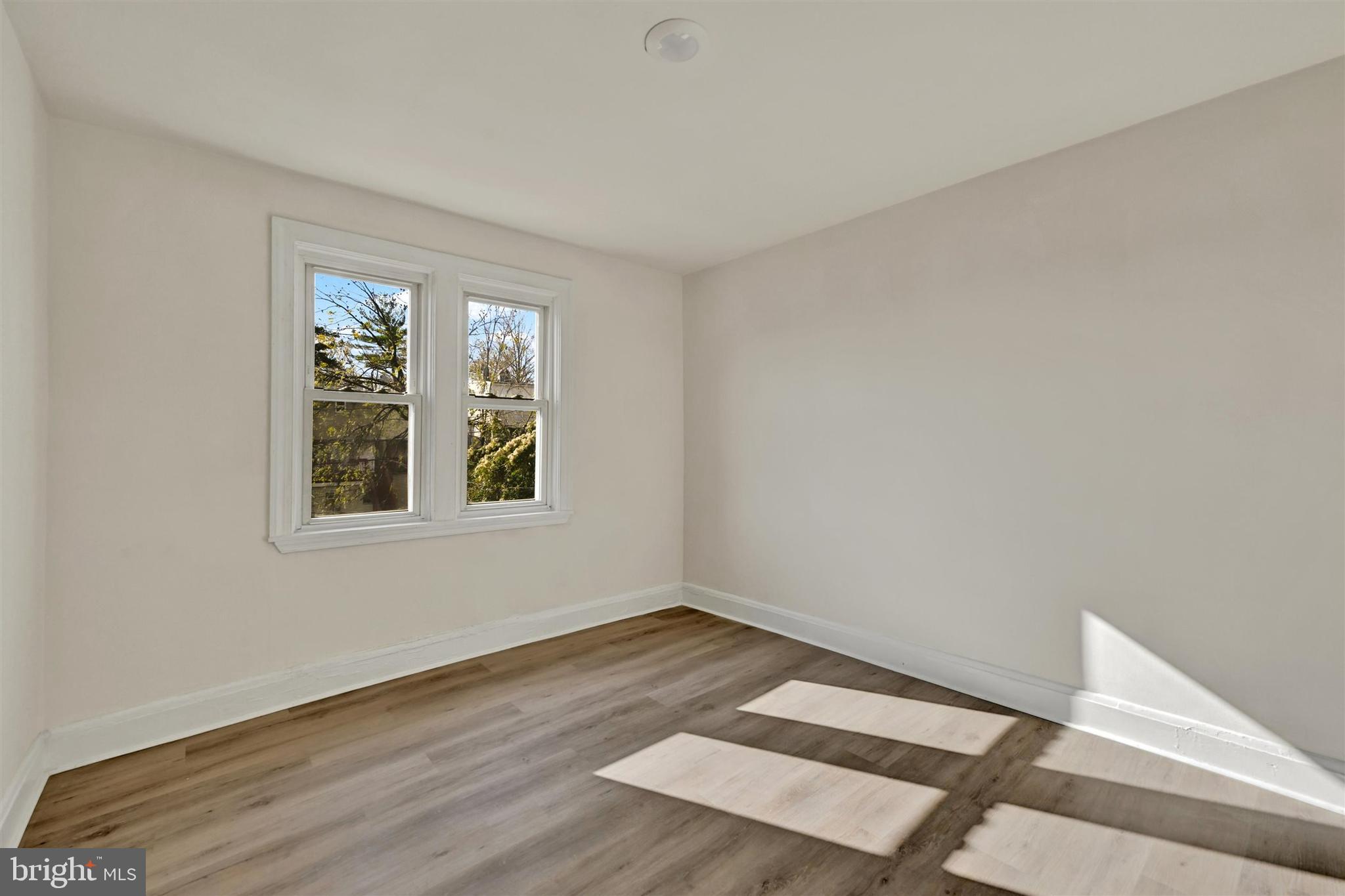 1509 Filbert Street Curtis Bay, MD 21226 - Photo 19 of 28 a view of an empty room with wooden floor and a window