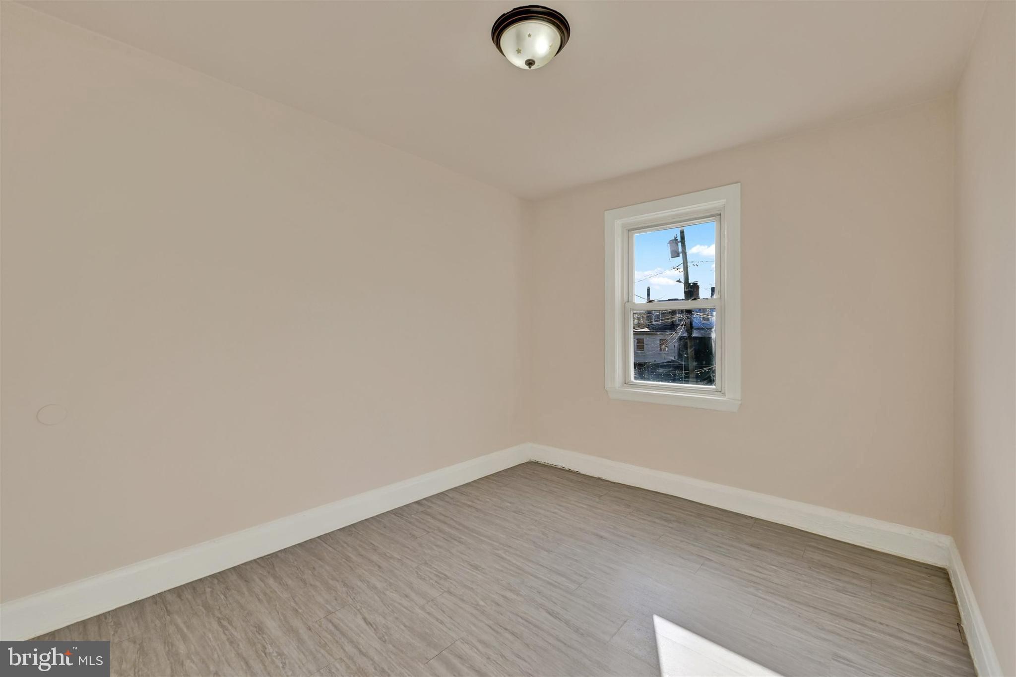 1509 Filbert Street Curtis Bay, MD 21226 - Photo 3 of 28 an empty room with wooden floor and windows