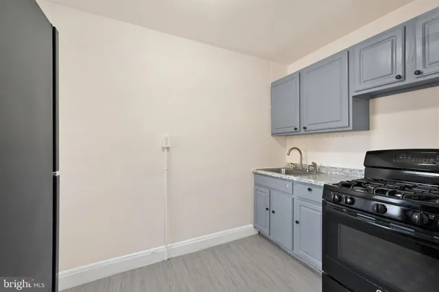 a kitchen with stainless steel appliances granite countertop a stove and a refrigerator