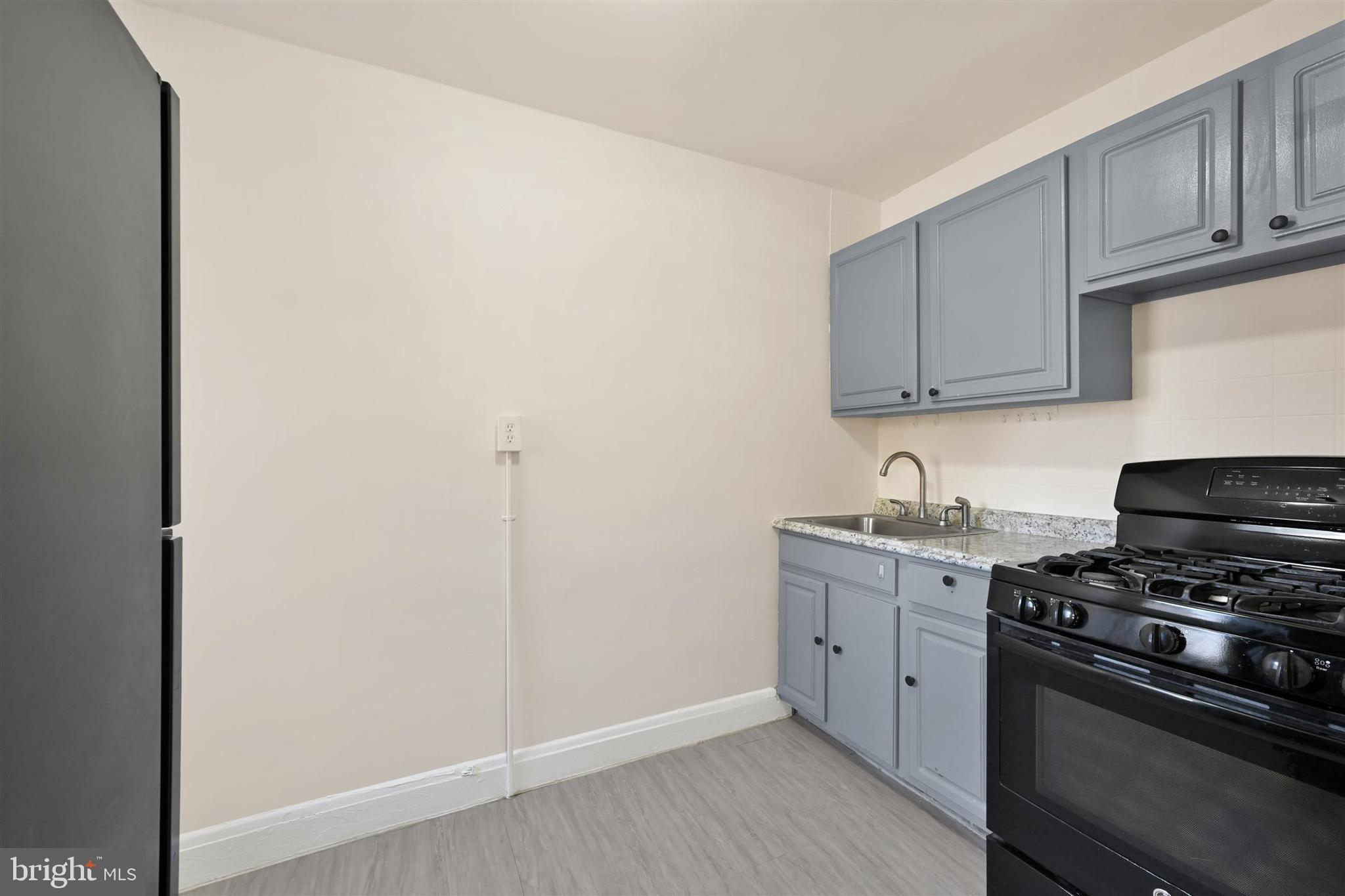 1509 Filbert Street Curtis Bay, MD 21226 - Photo 5 of 28 a kitchen with stainless steel appliances granite countertop a stove and a refrigerator
