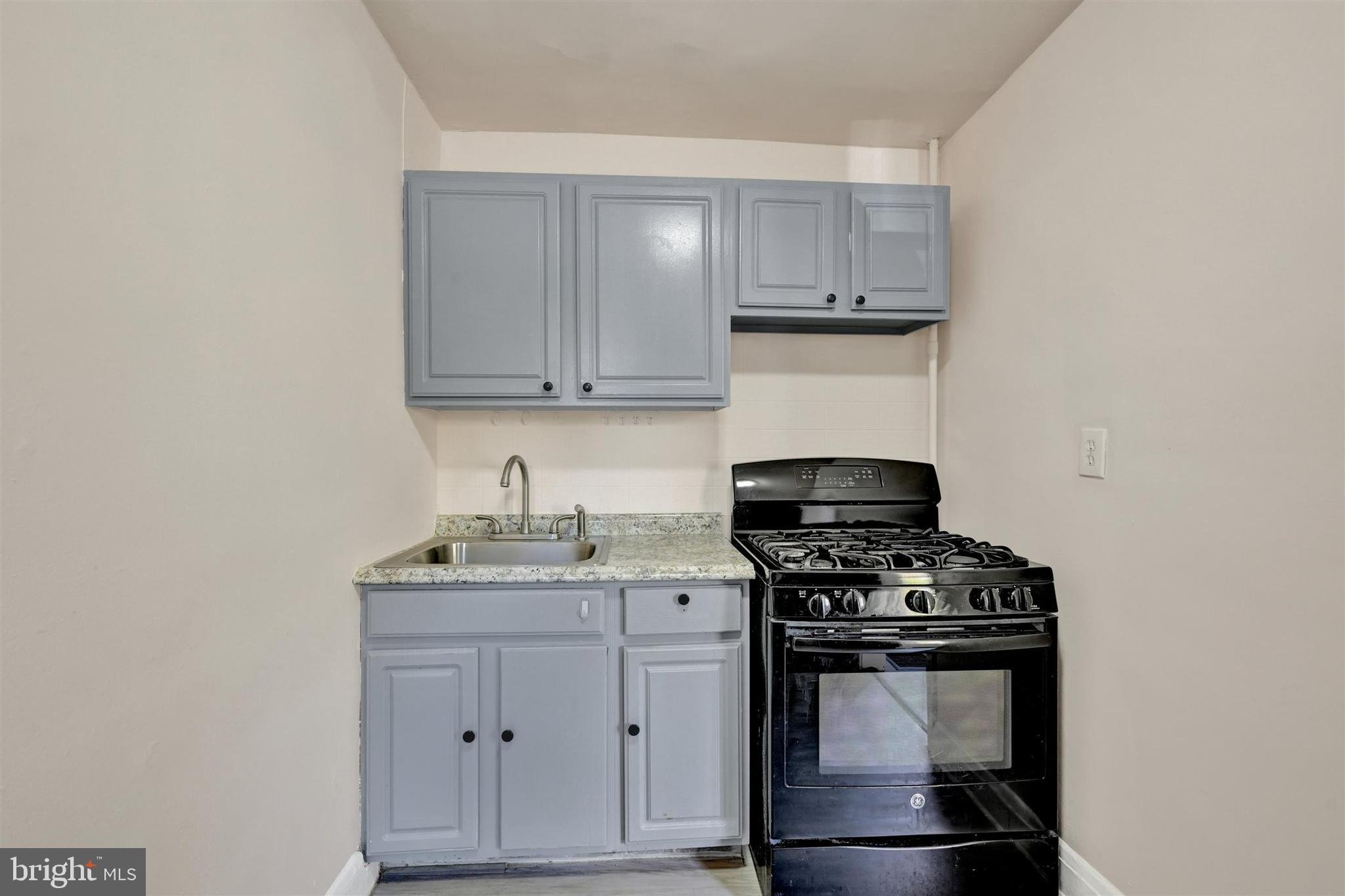 1509 Filbert Street Curtis Bay, MD 21226 - Photo 6 of 28 a kitchen with granite countertop a stove and a sink