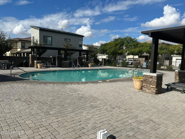 a view of a house with backyard porch and sitting area