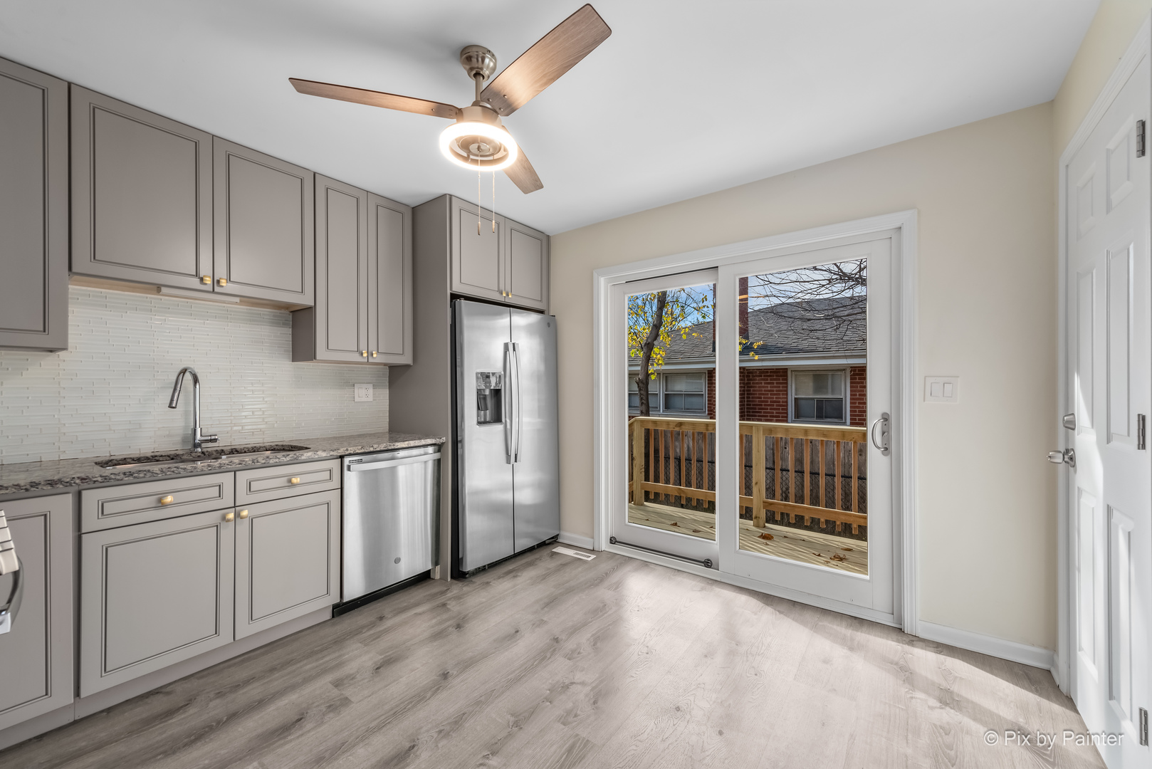 909 Oakton Street Park Ridge, IL 60068 - Photo 6 of 18 a kitchen with stainless steel appliances granite countertop a stove top oven a sink and a refrigerator with wooden floor