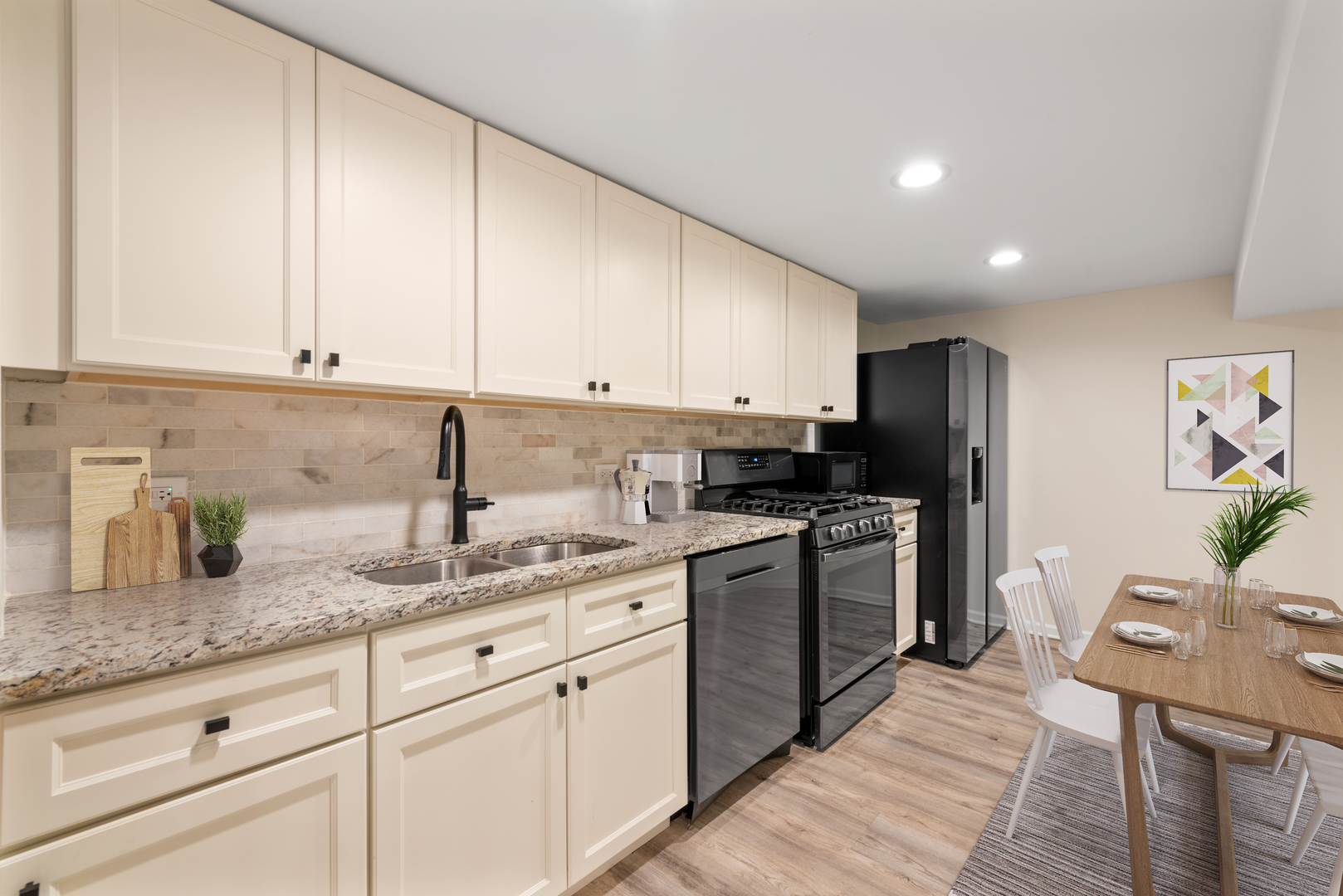 909 Oakton Street Park Ridge, IL 60068 - Photo 7 of 18 a kitchen with stainless steel appliances granite countertop a sink dishwasher stove and refrigerator with wooden floor