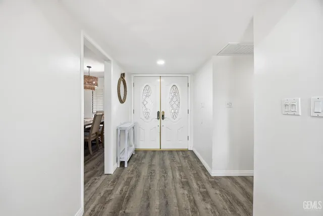 a view of a room with wooden floor and white walls