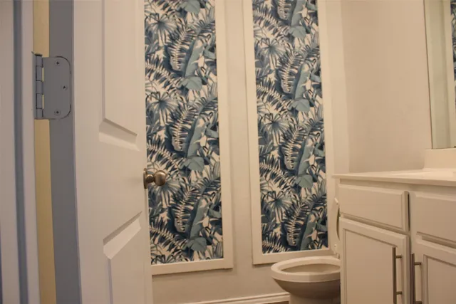 a bathroom with a toilet and a shower curtain