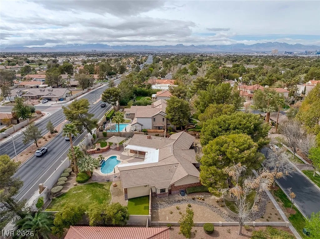 9 Quail Run Road Henderson, NV 89014 - Photo 50 of 57 An aerial perspective showcases the spacious lot, sparkling pool, and surrounding green landscape of this suburban residence.
