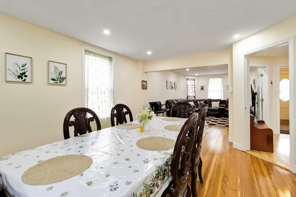 a dining room with furniture and wooden floor