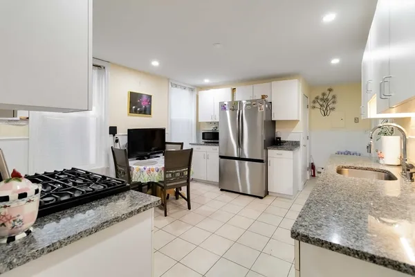 a kitchen with a refrigerator and a sink