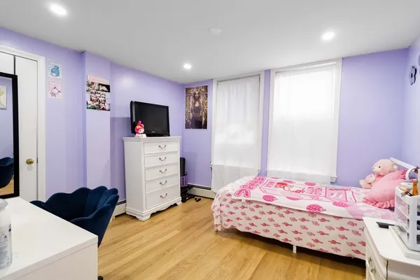 a bedroom with a bed and a flat tv screen