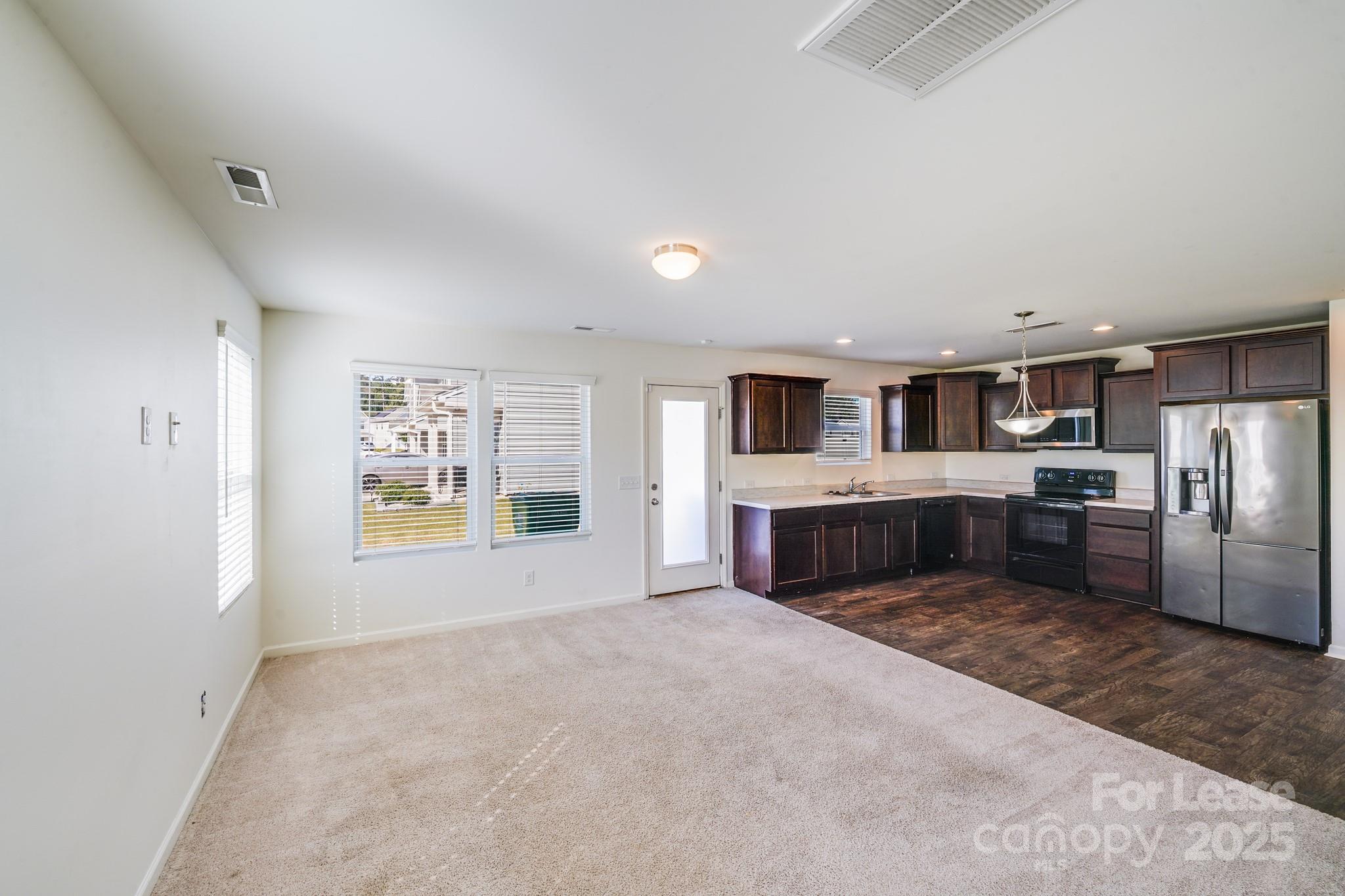 12915 Hill Pine Road Midland, NC 28107 - Photo 13 of 31 a large white kitchen with stainless steel appliances granite countertop a refrigerator and a stove top oven