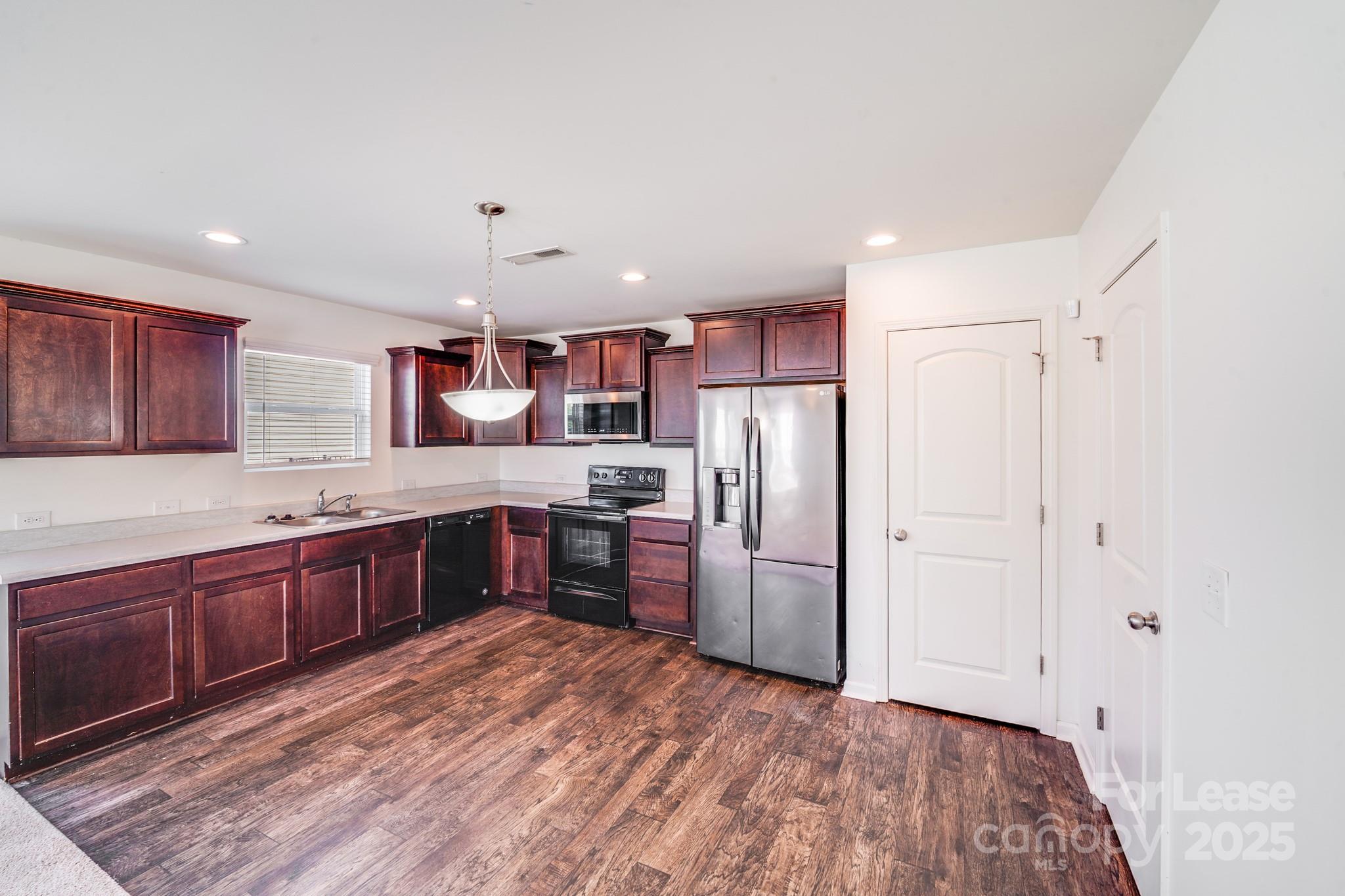 12915 Hill Pine Road Midland, NC 28107 - Photo 15 of 31 a large kitchen with a refrigerator and a sink