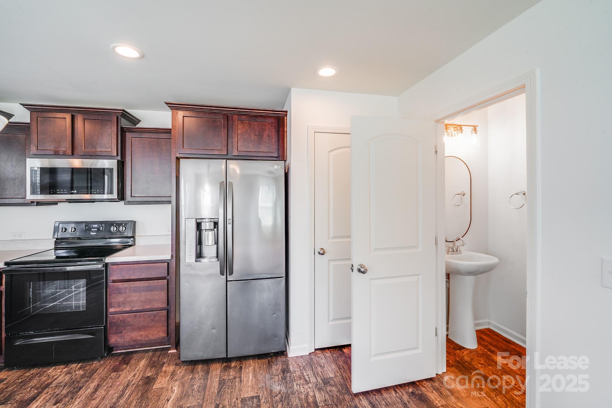 12915 Hill Pine Road Midland, NC 28107 - Photo 16 of 31 a kitchen with stainless steel appliances granite countertop a refrigerator and a stove top oven
