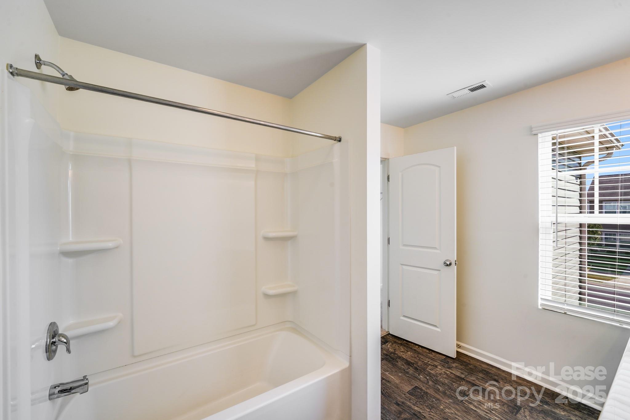 12915 Hill Pine Road Midland, NC 28107 - Photo 25 of 31 a bathroom with a bathtub and a shower