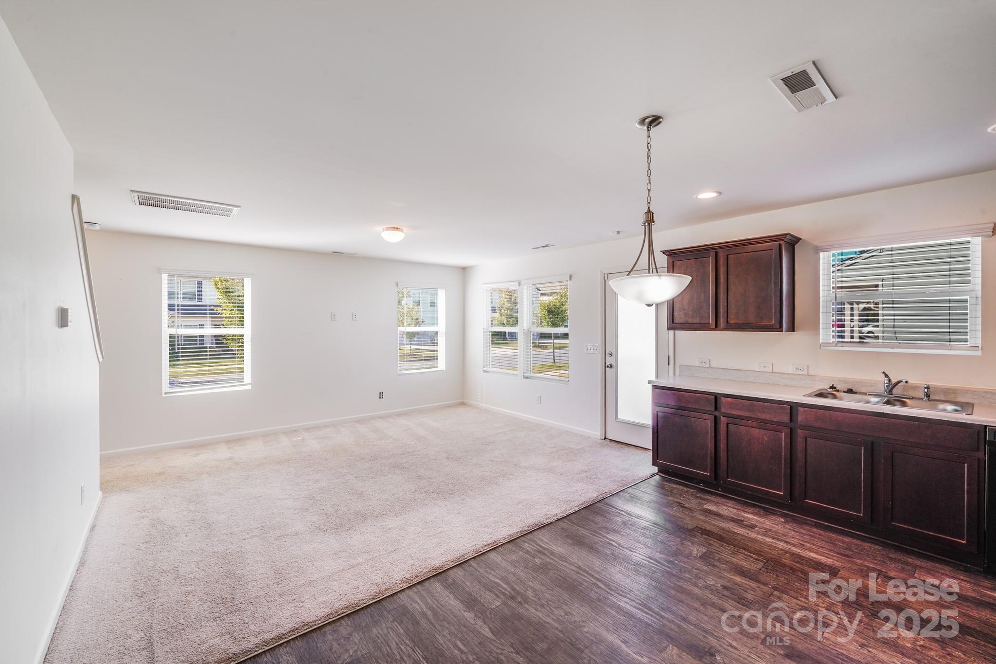 12915 Hill Pine Road Midland, NC 28107 - Photo 4 of 31 a large kitchen with granite countertop a stove a sink a window and dining table