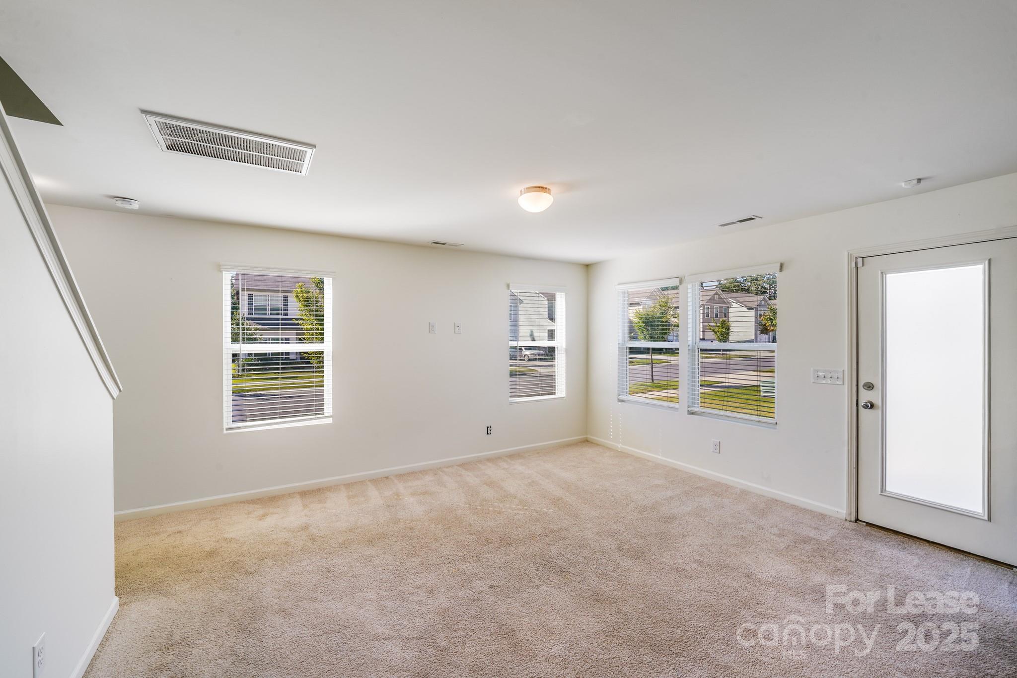 12915 Hill Pine Road Midland, NC 28107 - Photo 8 of 31 a view of an empty room with a window and a kitchen