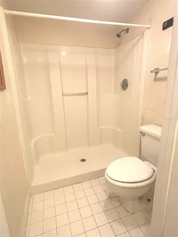 a bathroom with a toilet and shower