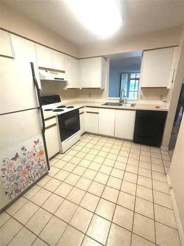a kitchen with granite countertop a black white checkered floor