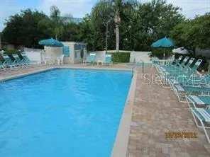 a view of a patio with furniture and a garden