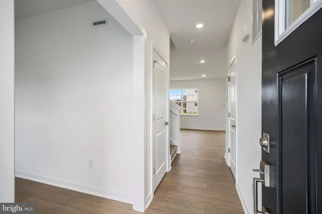 a view of a hallway with wooden floor