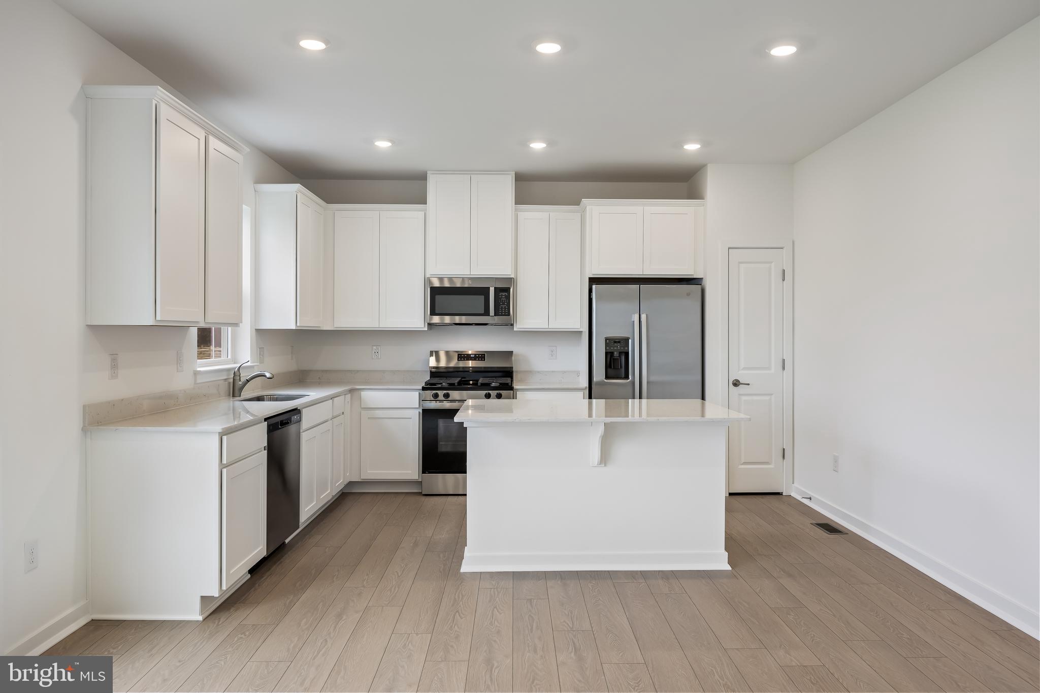 13 Inkwell Lane Sicklerville, NJ 08081 - Photo 10 of 37 a large kitchen with stainless steel appliances granite countertop a stove a sink a refrigerator and white cabinets with wooden floor