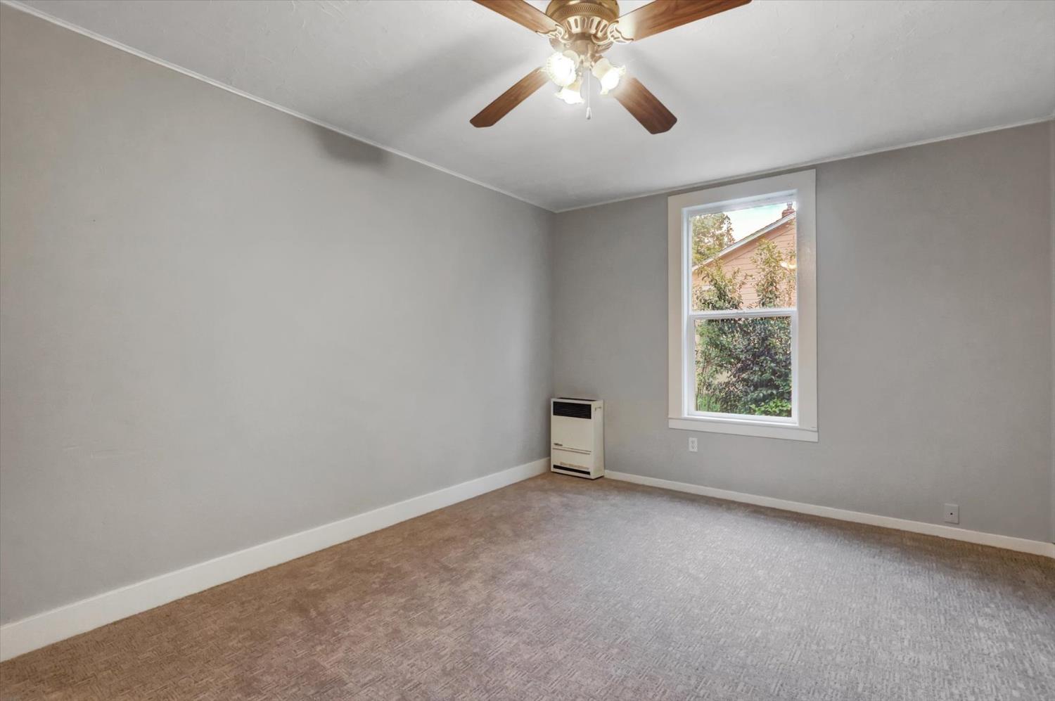 618 Walsh Street Grass Valley, CA 95945 - Photo 14 of 32 an empty room with a window and a fan